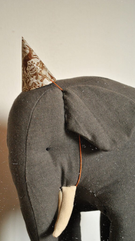 Handmade fabric elephant toy Boran photographed in natural light in art studio