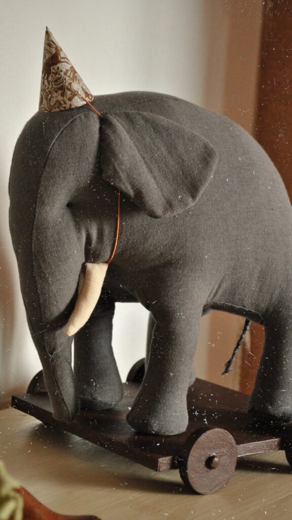 Handmade fabric elephant toy Boran photographed in natural light in art studio