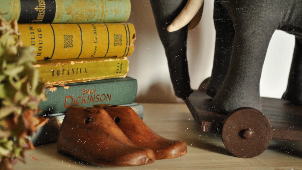 Vintage-style elephant doll standing on handcrafted wooden base.