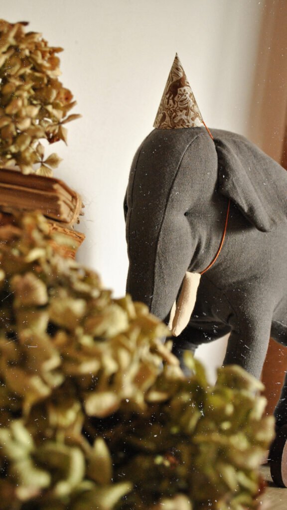 Handmade fabric elephant toy Boran photographed in natural light in art studio