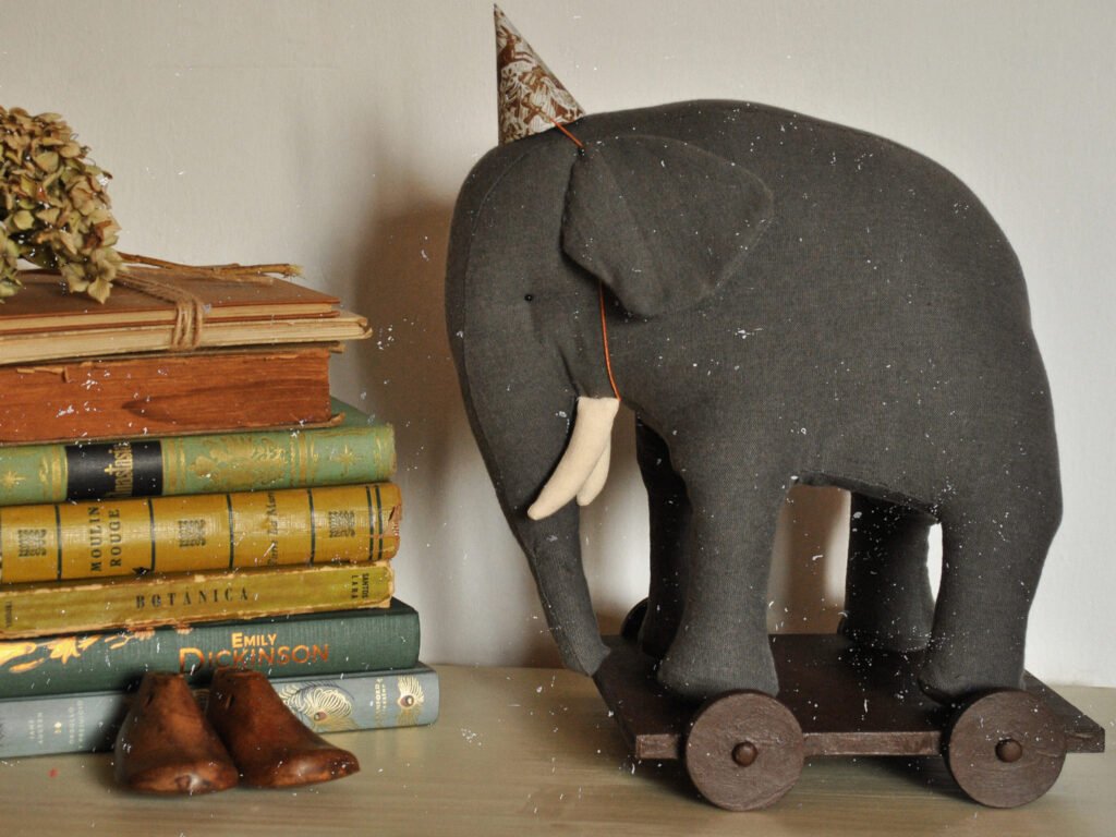 Handmade fabric elephant toy Boran photographed in natural light in art studio